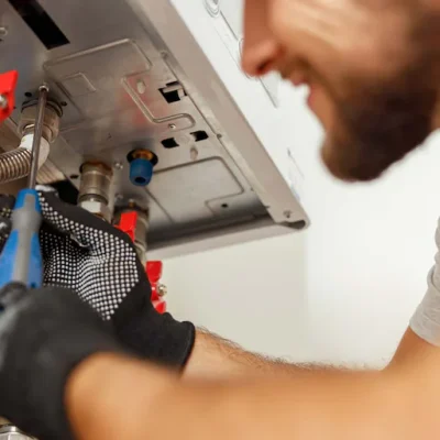 professional-inspecting-under-water-heater