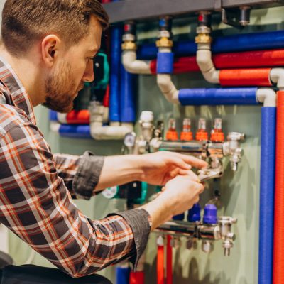 Young engineer adjusting autonomous heating